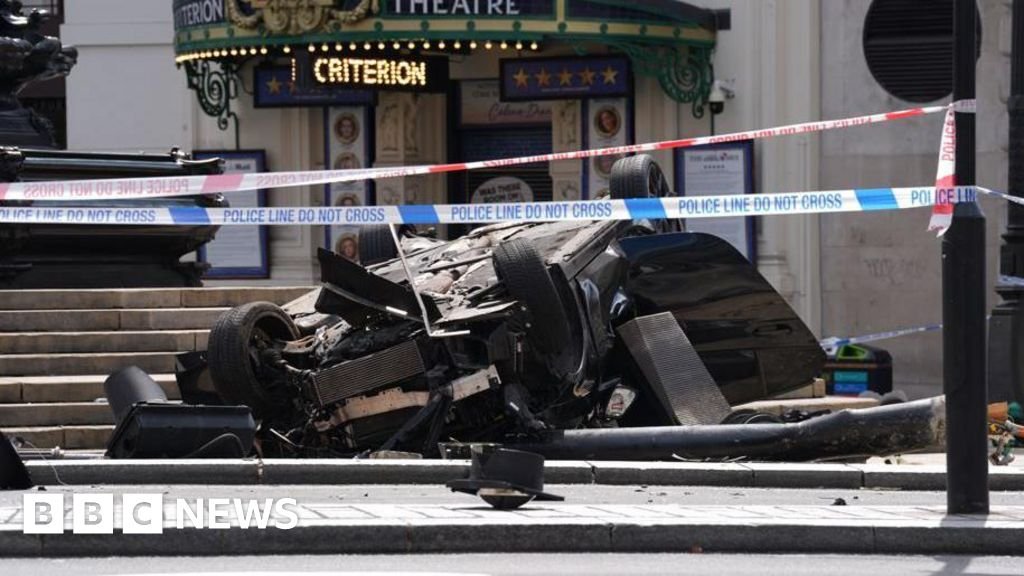Car crashes and overturns by Eros statue